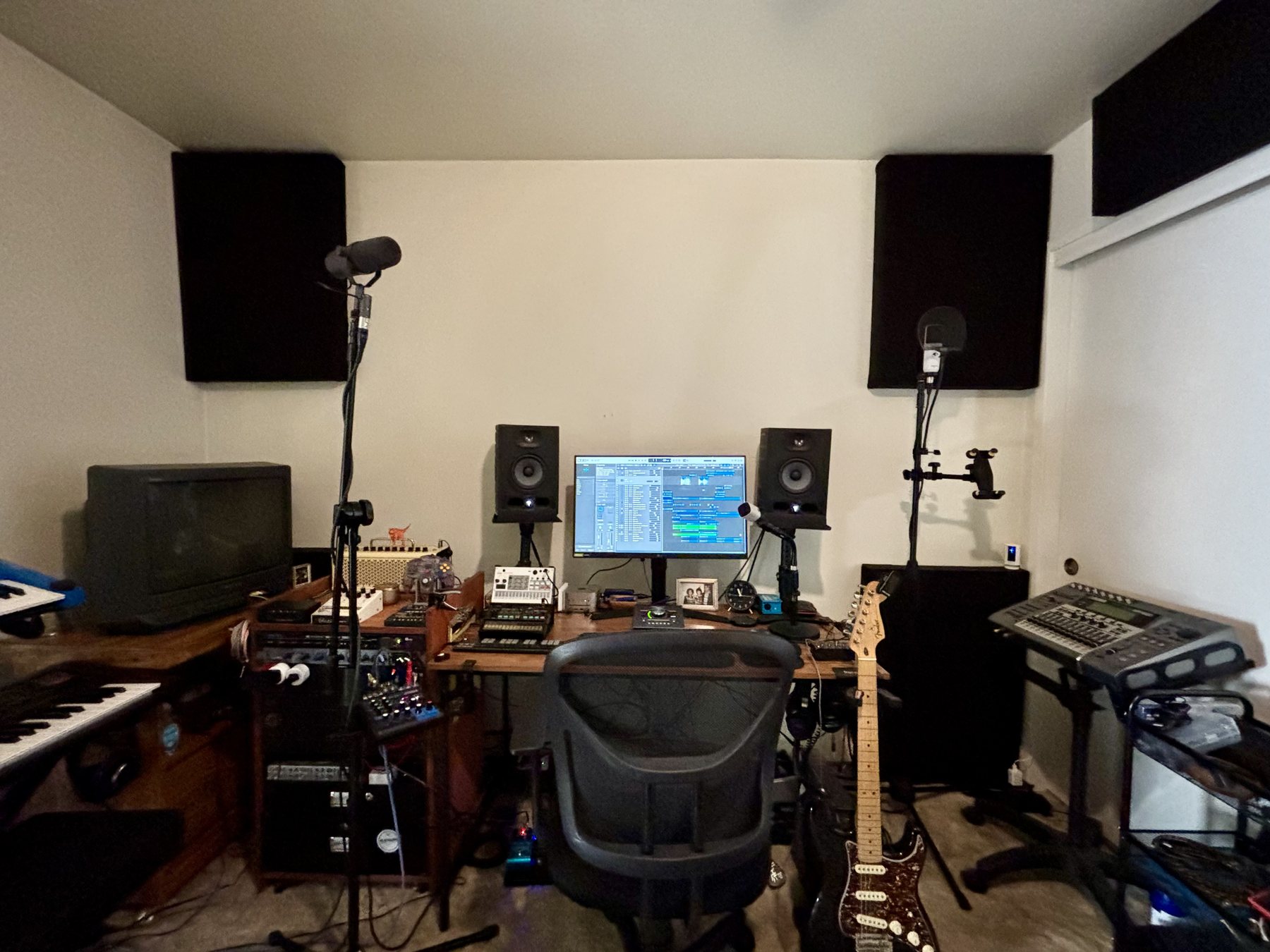 Recording workstation with monitor speakers, microphones, and audio equipment